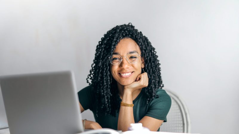 happy-ethnic-woman-sitting-at-table-with-laptop-3769021.jpg